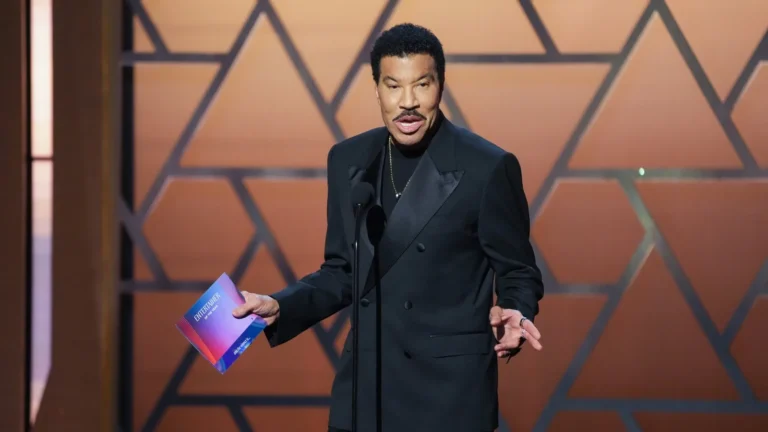 Lionel Richie performing onstage during a concert tour with Earth, Wind & Fire