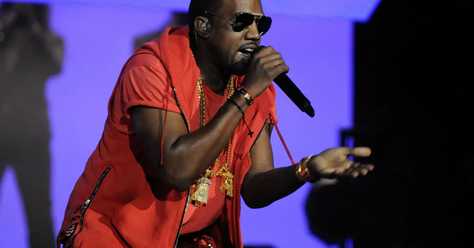 Kanye West performing on stage during a concert announcement