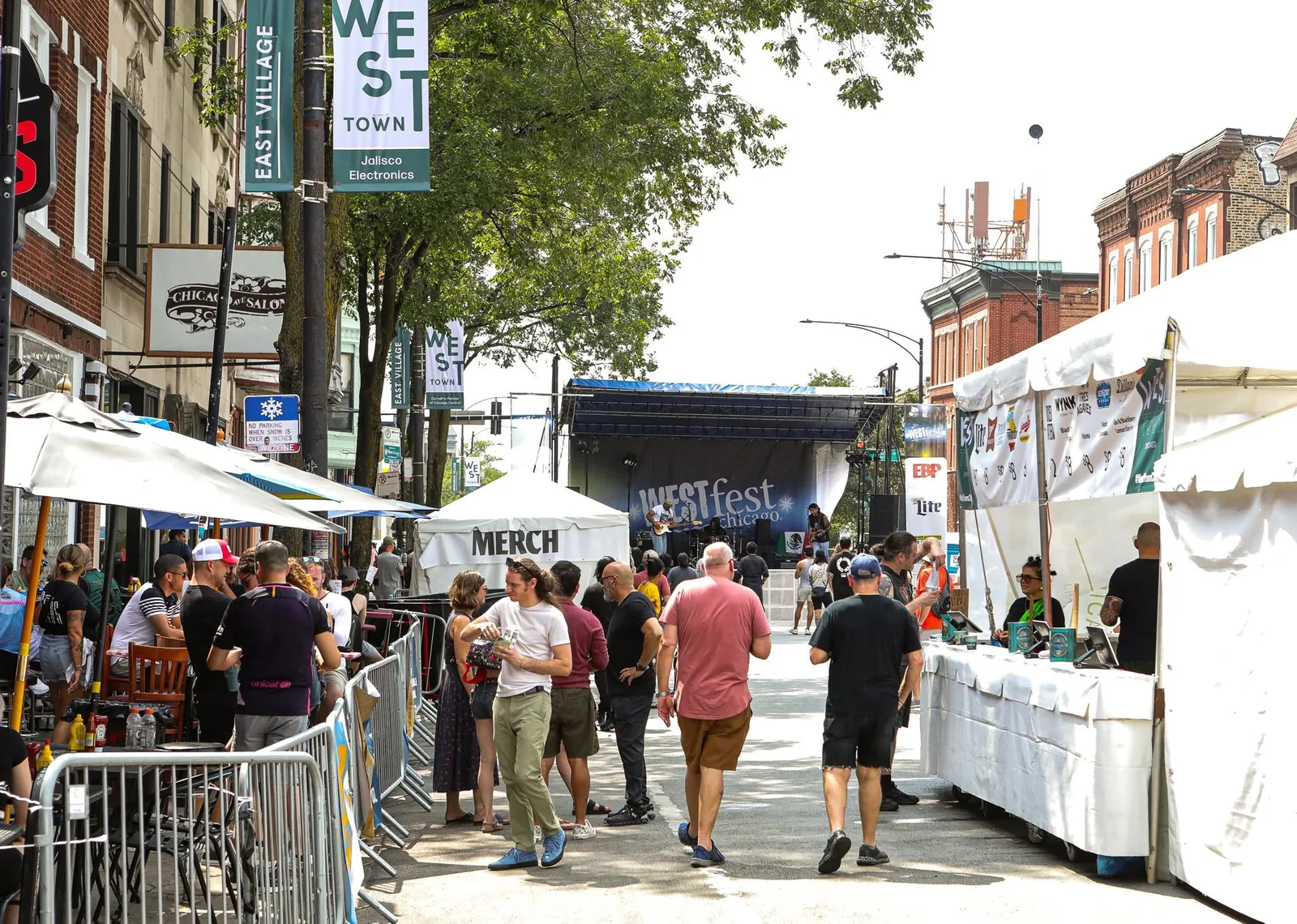 Crowds browse festival booths and outdoor vendors at a Chicago summer street festival