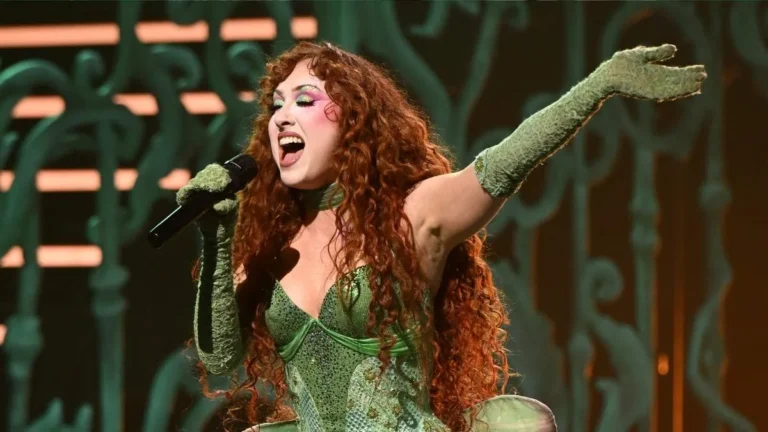 Chappell Roan performing onstage while discussing the backstory behind her song Casual