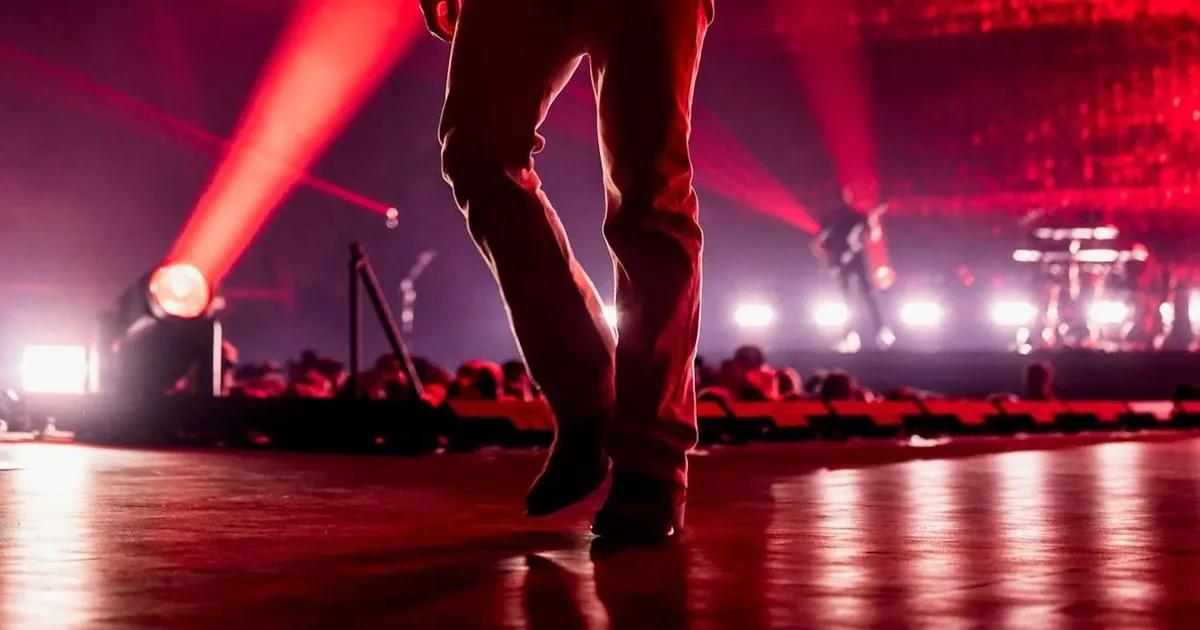 Morgan Wallen performing onstage during a country concert tour stop