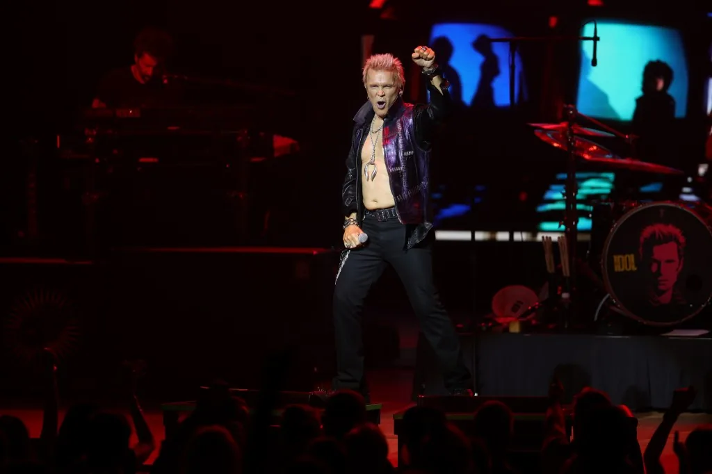 Billy Idol performing onstage at Ravinia Festival with his signature rock-and-roll swagger