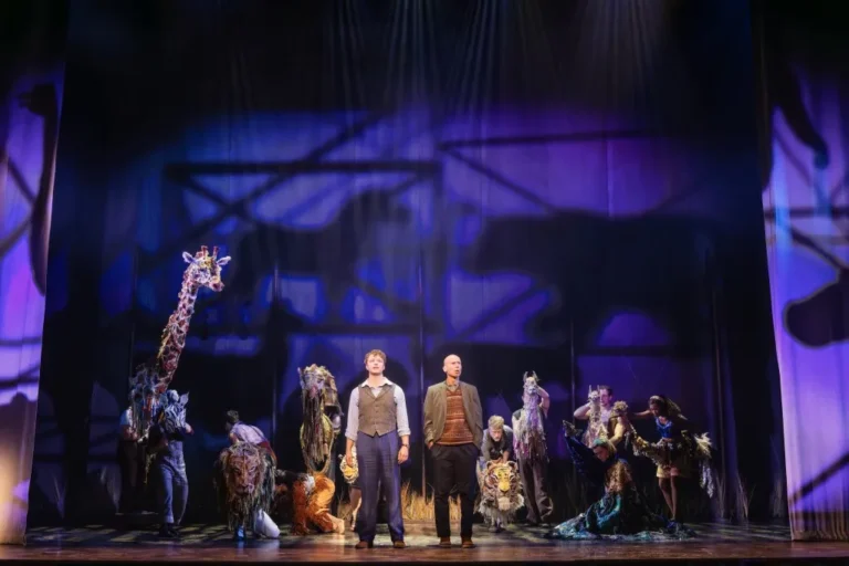 A stage musical with circus performers and large animal puppets at Chicago's Nederlander Theatre