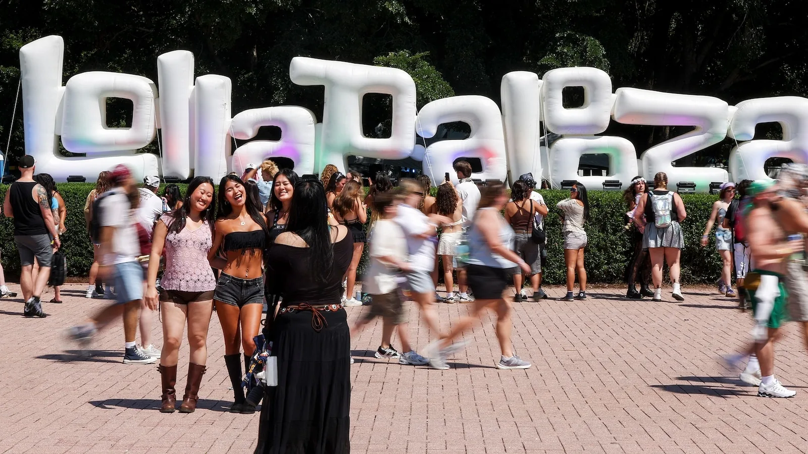 Crowds and stage lights at Lollapalooza with festivalgoers watching a live performance