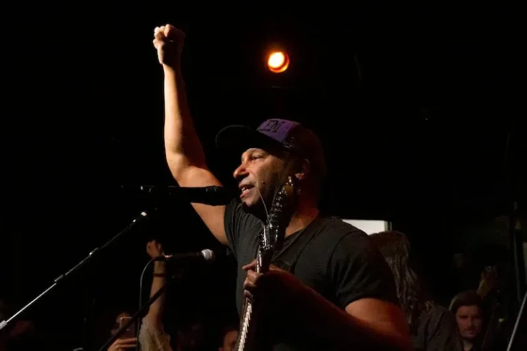 Tom Morello performing with a guitar on stage during a concert