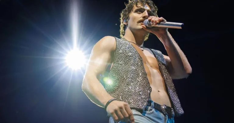 Benson Boone performs shirtless onstage during a flip-heavy concert in New Orleans