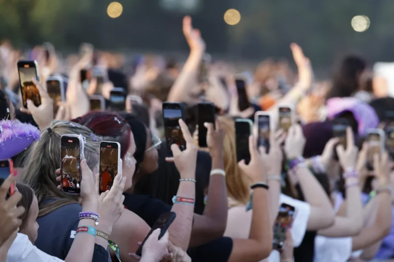 Concertgoers packed tightly in a general admission floor section near the stage