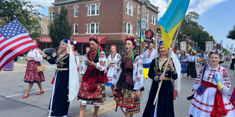 Marchers in traditional dress carry Ukrainian flags during a Unity March in Chicago's Ukrainian Village
