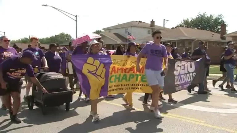 Union members march with colorful floats along Ewing Avenue during Chicago's Labor Day Parade