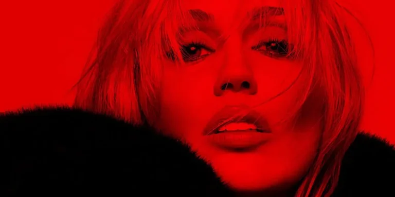 Miley Cyrus in a fur coat posing for a red-themed new music teaser