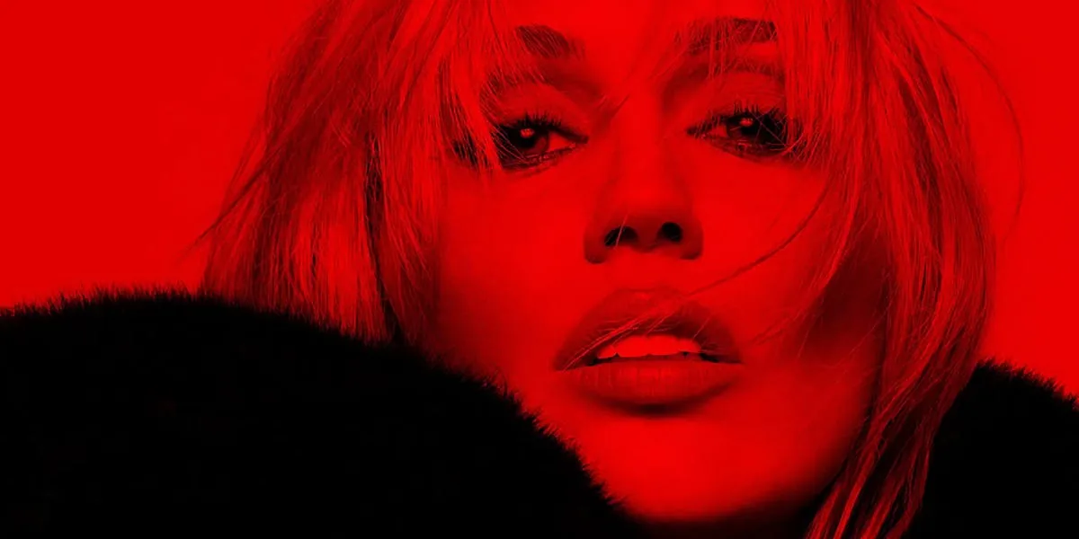 Miley Cyrus in a fur coat posing for a red-themed new music teaser