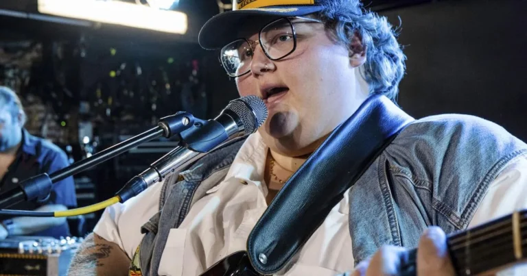 Joshua Ray Walker performs with a guitar onstage during his cancer-trilogy tour