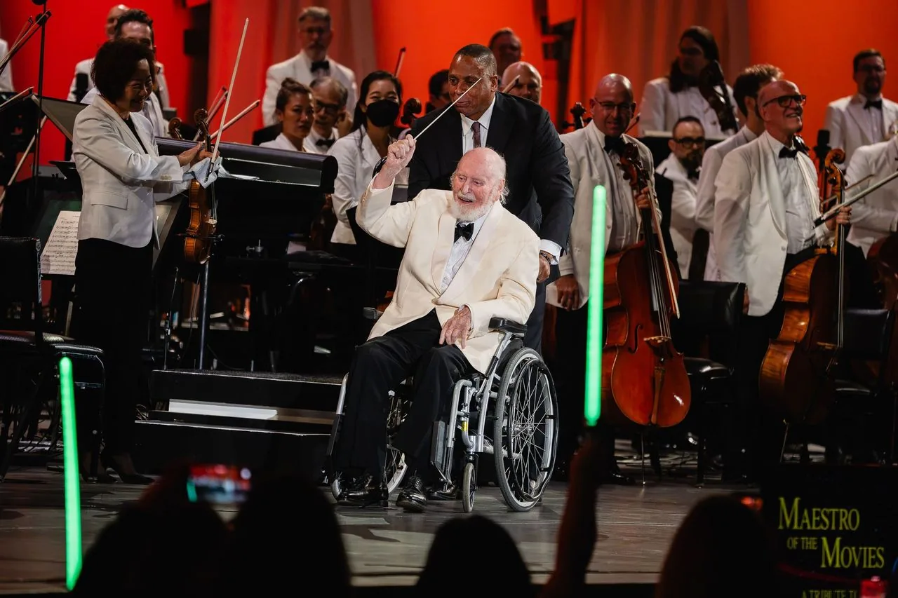 John Williams conducts The Imperial March at the Hollywood Bowl while fans hold up glowing lightsabers