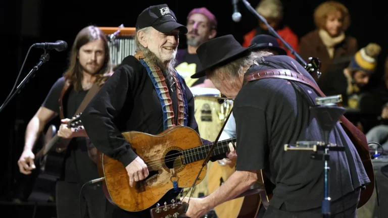 Willie Nelson and Neil Young performing together at a benefit concert