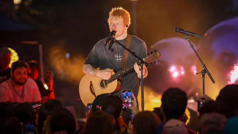 Ed Sheeran performing onstage during a stadium tour amid lineup changes