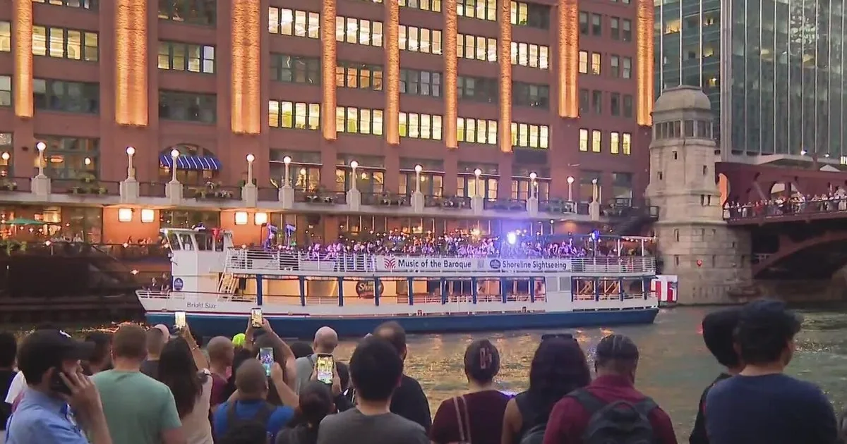 Crowds line the Chicago River Riverwalk to watch Music of the Baroque perform from the water