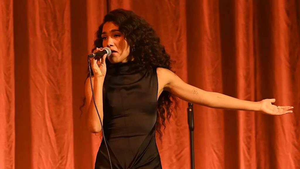 Olivia Dean performing onstage as a copyright lawsuit challenges her song I’ve Seen It
