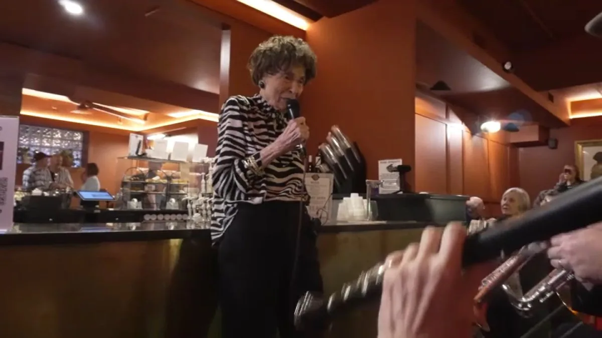 Pat McArtor sings during a birthday celebration at St. Elmo’s Coffee Pub in Alexandria