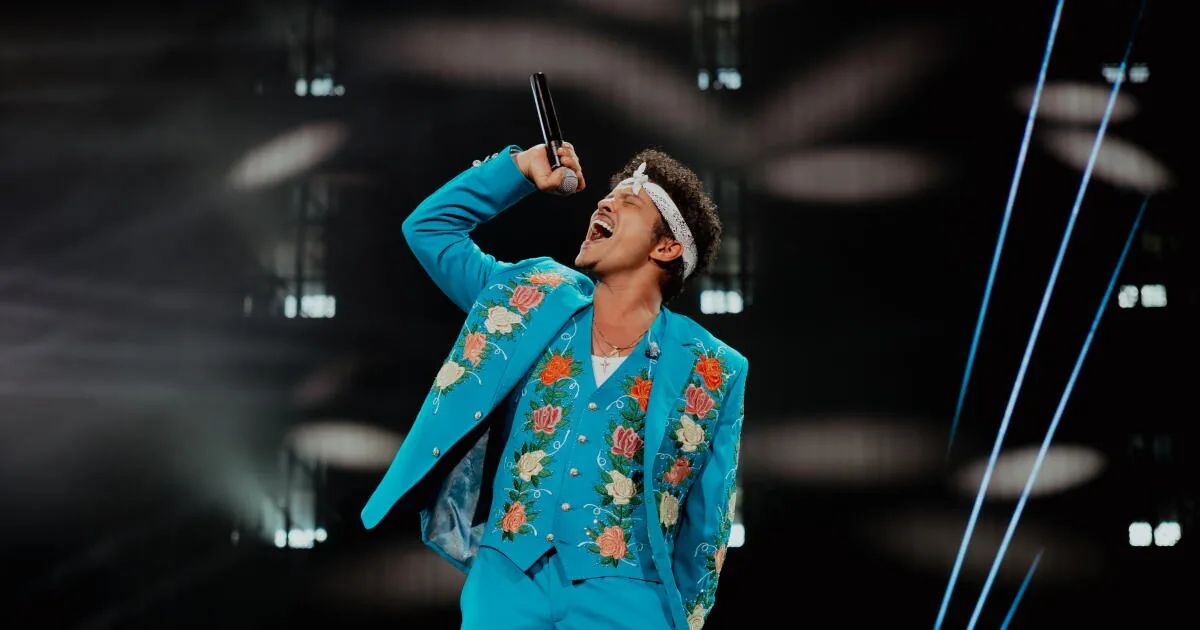 Bruno Mars performs at SoFi Stadium during a polished concert with elaborate staging and floral suits