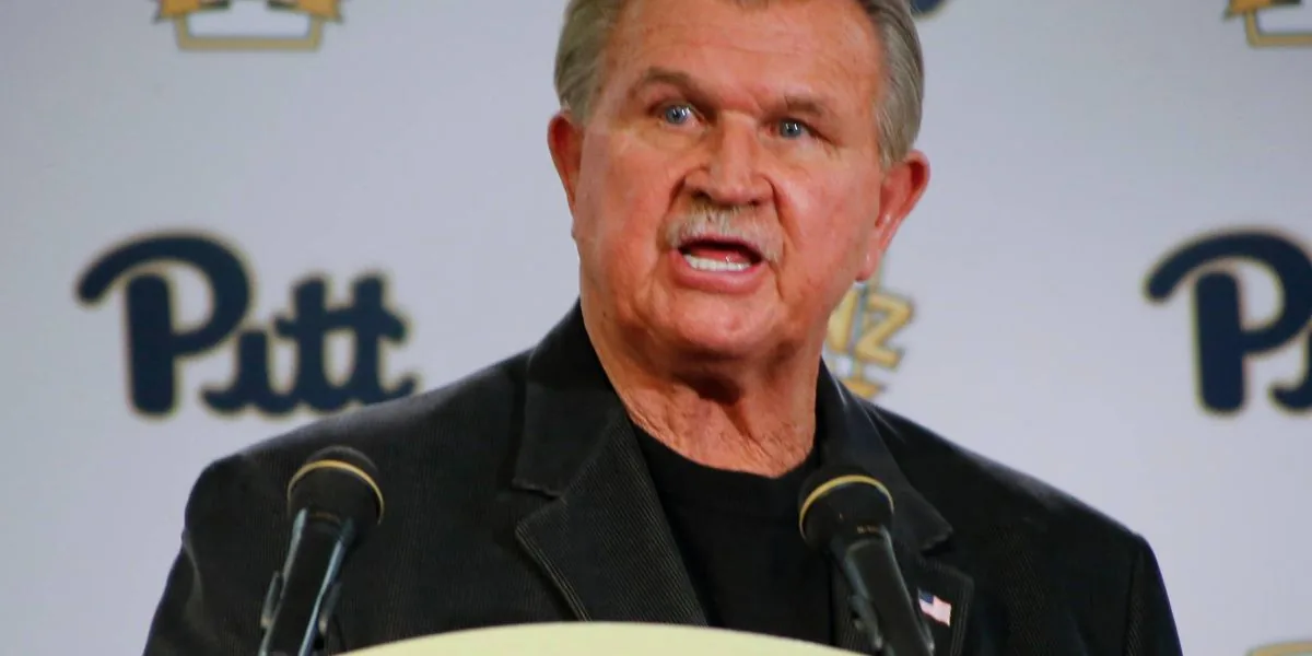 Mike Ditka stands on the sideline in a Chicago Bears jacket during his coaching era